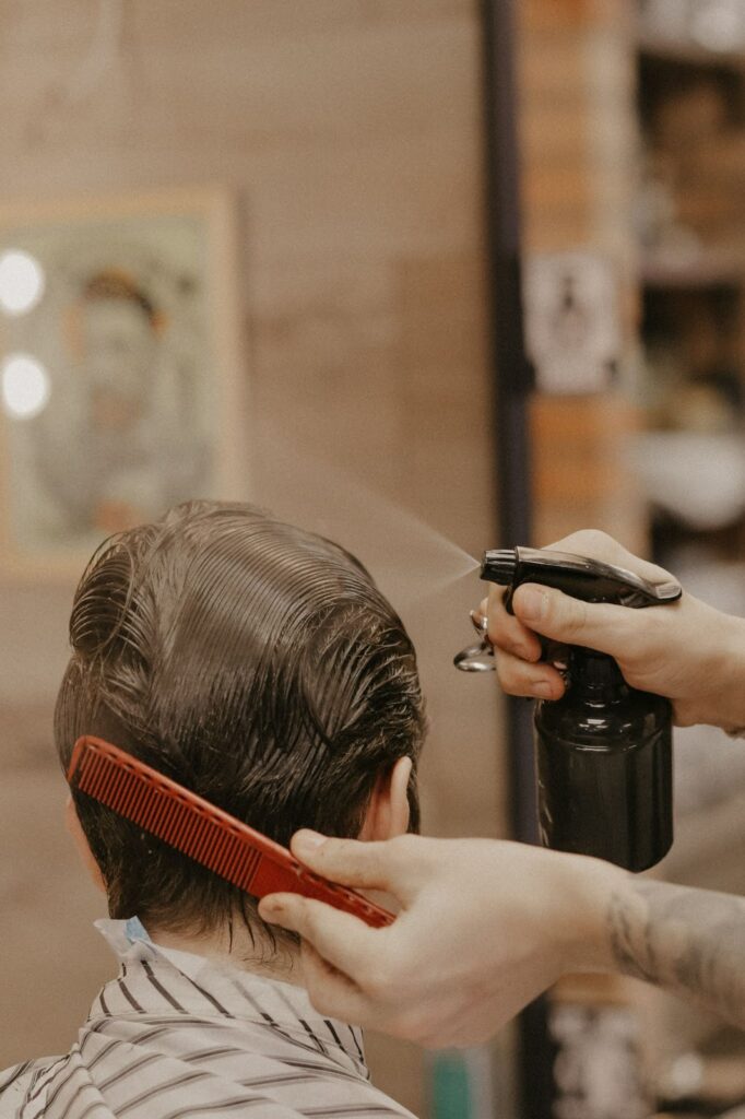 Premium Photo  A hair stylist trimming one side of boy's head